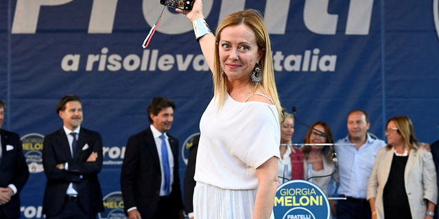 Giorgia Meloni, leader of the Brothers of Italy party, takes a selfie during a rally in Duomo square ahead of the Sept. 25 snap election, in Milan, Italy, September 11, 2022.