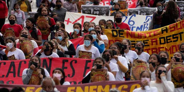 People in Mexico march in Mexico City, Mexico, on the anniversary of the day 43 Mexican students went missing on Sept. 26, 2022.