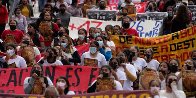 People in Mexico march in Mexico City, Mexico, on the anniversary of the day 43 Mexican students went missing on Sept. 26, 2022.
