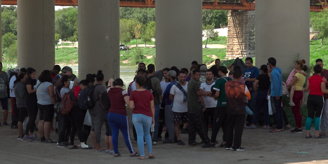 Customs and Border Protection agents process migrants who crossed into the U.S. through the Rio Grande.