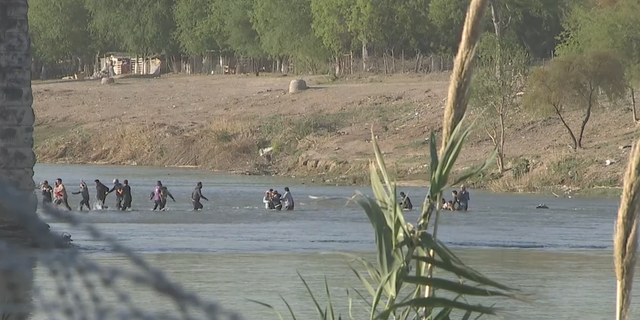 Migrants crossing the Rio Grande into Eagle Pass, Texas.