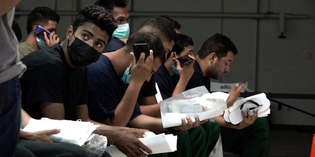 Migrants wait to be checked in to the city of El Paso's Migrant Welcome Center Sept. 22, 2022.