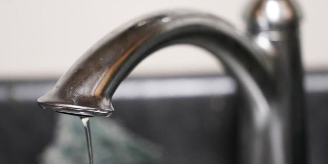A trickle of water comes out of the faucet of Mary Gaines a resident of the Golden Keys Senior Living apartments in her kitchen in Jackson, Miss., Thursday, Sept. 1, 2022.