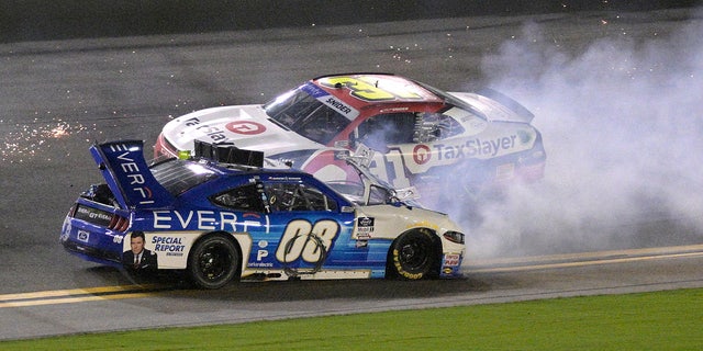 David Starr (08) slides backwards along the front stretch after getting in a multi-car wreck as Myatt Snider (31) passes him during a NASCAR Xfinity Series auto race at Daytona International Speedway, Saturday, Aug. 27, 2022, in Daytona Beach, Fla.