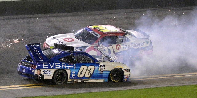 David Starr (08) slides backwards along the front stretch after getting in a multi-car wreck as Myatt Snider (31) passes him during a NASCAR Xfinity Series auto race at Daytona International Speedway, Saturday, Aug. 27, 2022, in Daytona Beach, Fla.