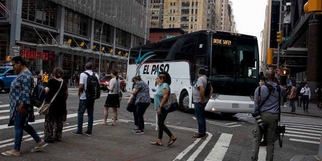 A bus from Texas carrying migrants arrives in New York City.