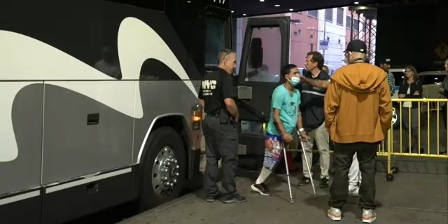 A migrant on crutches and missing a limb disembarks a bus at Port Authority in New York City on Sept. 18, 2022.