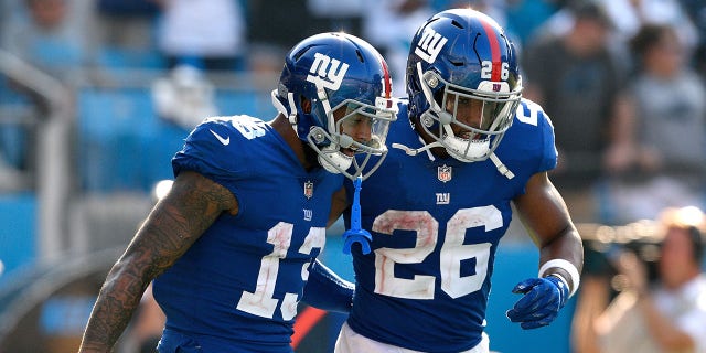 Odell Beckham Jr. and Saquon Barkley of the New York Giants against the Panthers at Bank of America Stadium on Oct. 7, 2018, in Charlotte, North Carolina.