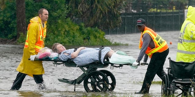 Authorities transport a person out of the Avante nursing home in the aftermath of Hurricane Ian, on Thursday, Sept. 29, 2022, in Orlando, Florida. Fr. Jeffrey Kirby of Indian Land, South Carolina, called the Lord "the master of storms and protector of your people."