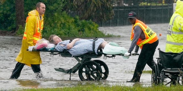 Authorities transport a person out of the Avante nursing home in the aftermath of Hurricane Ian, on Thursday, Sept. 29, 2022, in Orlando, Florida. Fr. Jeffrey Kirby of Indian Land, South Carolina, called the Lord "the master of storms and protector of your people."