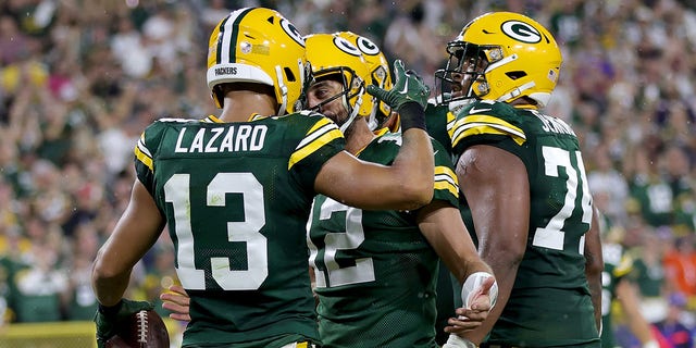 Allen Lazard #13 of the Green Bay Packers celebrates a touchdown with Aaron Rodgers #12 during the first half in the game against the Chicago Bears at Lambeau Field on September 18, 2022, in Green Bay, Wisconsin.