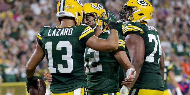 Allen Lazard #13 of the Green Bay Packers celebrates a touchdown with Aaron Rodgers #12 during the first half in the game against the Chicago Bears at Lambeau Field on September 18, 2022 in Green Bay, Wisconsin.