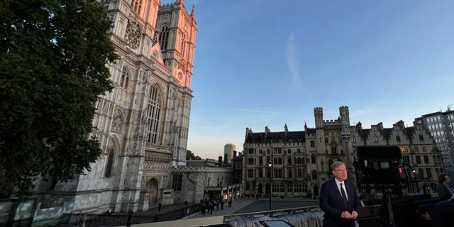 Greg Palkot stands in front of Westminster Hall during a live shot as mourners visit Queen Elizabeth II. 