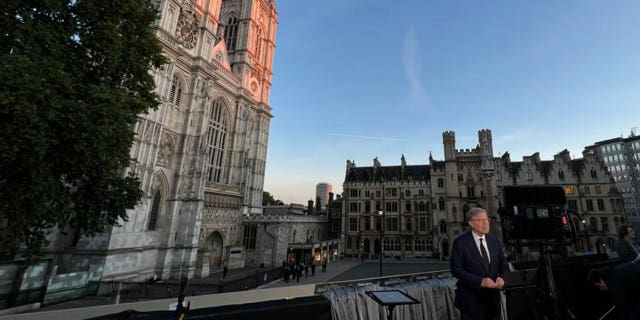 Greg Palkot stands in front of Westminster Hall during a live shot as mourners visit Queen Elizabeth II. 