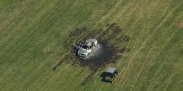 A burned-out car in the aftermath of a bomb squad training accident in which five law enforcement personnel were injured Thursday.