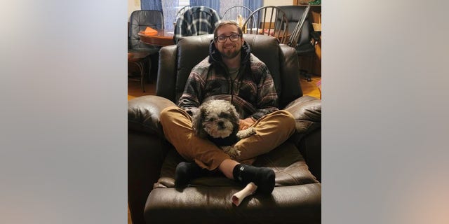 Phillip Lewis lounges with his "best friend" Little Dude.