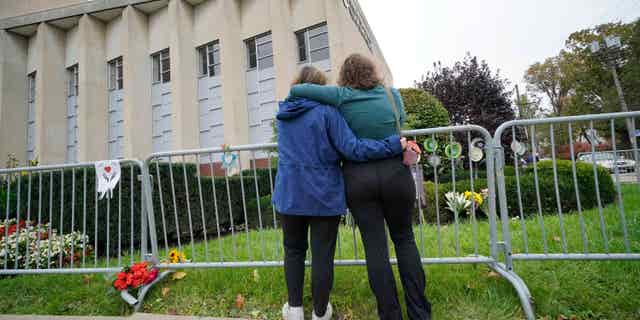 People pay respects to those killed in the 2018 Pittsburgh synagogue massacre at the Tree of Life synagogue in Pittsburgh, Pennsylvania, on Oct. 27, 2021.