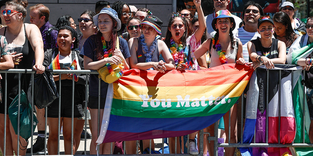 People carry the rainbow flag during the 51st Annual LGBTQ Pride Parade in Chicago, Illinois on June 26, 2022. 