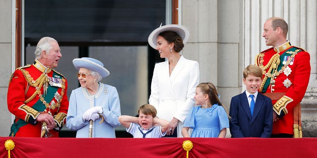 (L-R) Then-Prince Charles stands on the balcony of Buckingham Palace with Queen Elizabeth II, Prince Louis, Kate Middleton, Princess Charlotte, Prince George and Prince William in June during her Platinum Jubilee celebration. 