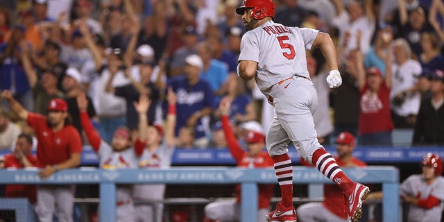 Albert Pujols #5 of the St. Louis Cardinals runs the bases as he hits and watches career homerun 699 against the Los Angeles Dodgers, to take a 2-0 lead, during the third inning at Dodger Stadium on September 23, 2022 in Los Angeles, California.