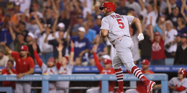Albert Pujols #5 of the St. Louis Cardinals runs the bases as he hits and watches career homerun 699 against the Los Angeles Dodgers, to take a 2-0 lead, during the third inning at Dodger Stadium on September 23, 2022 in Los Angeles, California.