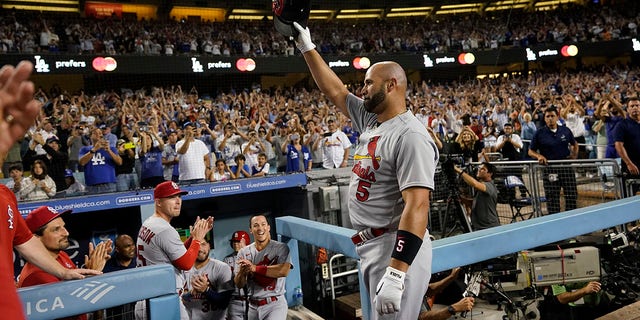 St.  Louis Cardinals designated hitter Albert Pujols (5) celebrates after hitting a home run during the fourth inning of a baseball game against the Los Angeles Dodgers in Los Angeles, Friday, Sept.  23, 2022. Brendan Donovan and Tommy Edman also scored.  It was Pujols' 700th career home run.