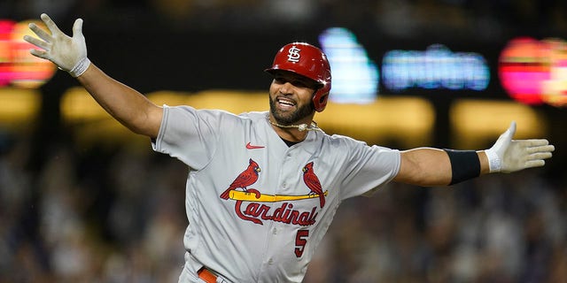 St. Louis Cardinals designated hitter Albert Pujols (5) reacts after hitting a home run during the fourth inning of a baseball game against the Los Angeles Dodgers in Los Angeles, Friday, Sept. 23, 2022. Brendan Donovan and Tommy Edman also scored. It was Pujols' 700th career home run.
