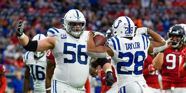 Indianapolis Colts running back Jonathan Taylor (28) celebrates his second half rushing touchdown with Indianapolis Colts guard Quenton Nelson (56)during the football game between the Indianapolis Colts and Houston Texans at NRG Stadium on December 5, 2021 in Houston, TX.