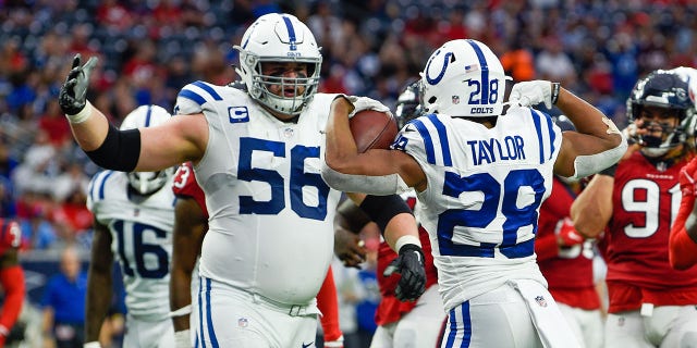 Indianapolis Colts running back Jonathan Taylor (28) celebrates his second half rushing touchdown with Indianapolis Colts guard Quenton Nelson (56)during the football game between the Indianapolis Colts and Houston Texans at NRG Stadium on December 5, 2021 in Houston, TX.