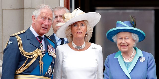 Then-Prince Charles, Prince of Wales, and then-Camilla, Duchess of Cornwall and Queen Elizabeth II watch a flypast to mark the centenary of the Royal Air Force from the balcony of Buckingham Palace on July 10, 2018 in London, England. 