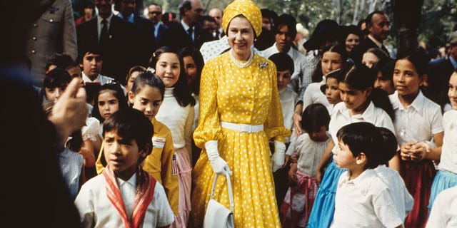 Queen Elizabeth II with a group of children during her state visit to Mexico in February-March 1975. 