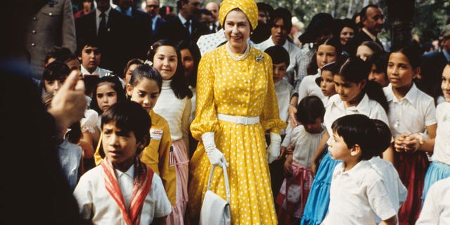 Queen Elizabeth II with a group of children during her state visit to Mexico in February-March 1975.