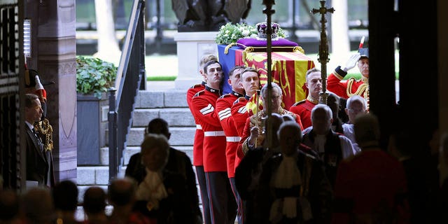 The coffin of Queen Elizabeth II is carried into Westminster Hall for the lying in state.