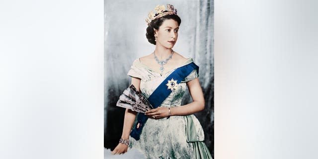 Queen Elizabeth stands for her official portrait.