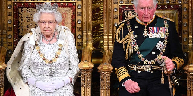 Queen Elizabeth II and Prince Charles in full court dress.