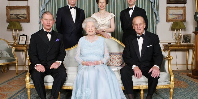 In this family portrait, Queen Elizabeth II sits with her husband Prince Phillip and four royal children, Prince Charles (now King Charles III), Princess Anne, Prince Andrew and Prince Edward.
