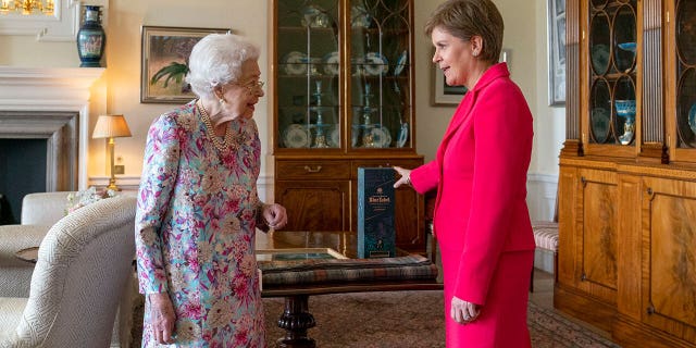 Britain's Queen Elizabeth II (left) greets Scottish Prime Minister and Scottish National Party leader Nicola Sturgeon.