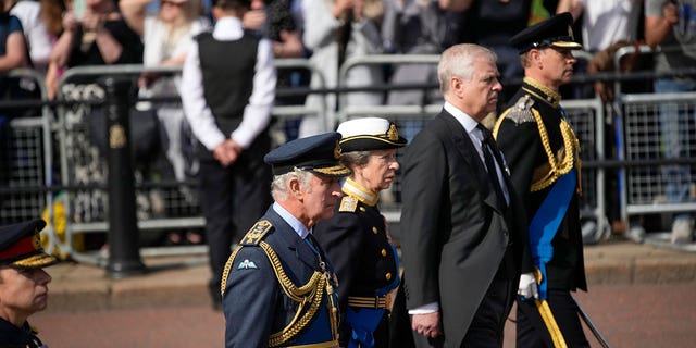 The royal family pictured in military uniforms during a procession to Westminster Hall.