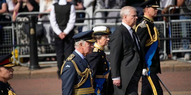 The royal family pictured in military uniforms during a procession to Westminster Hall.