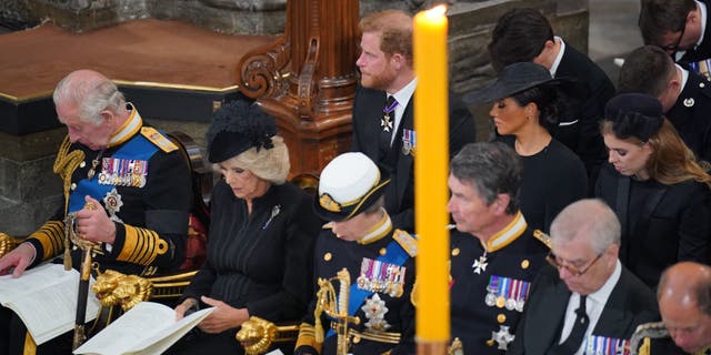 Prince Harry and Meghan Markle sit behind King Charles III and Queen Consort Camilla at Queen Elizabeth II's funeral on Sept. 19, 2022.