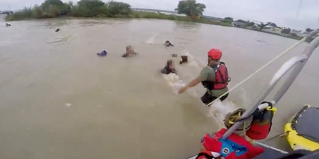 A Border Patrol officer jumps in the Rio Grande to help five migrants who were struggling to treat water.