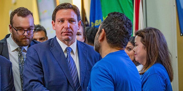 Florida Governor Ron DeSantis shakes hands with members of the Florida Department of Transportation as he leaves a press conference on toll relief at the Florida Department of Transportation District 6 headquarters in Miami on Wednesday, September 7, 2022.  (Sydney Walsh/Miami Herald/Tribune News Service via Getty Images)