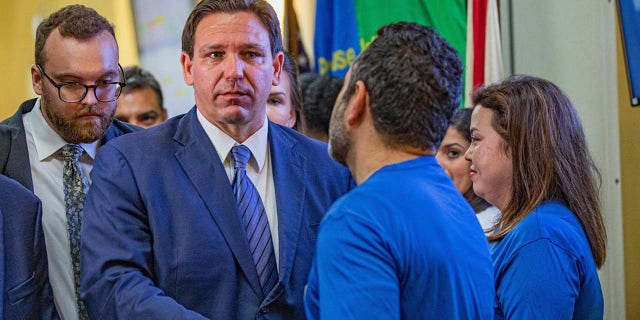 Florida Governor Ron DeSantis shakes hands with members of the Florida Department of Transportation as he leaves a press conference on toll relief at the Florida Department of Transportation District 6 headquarters in Miami on Wednesday, September 7, 2022.  (Sydney Walsh/Miami Herald/Tribune News Service via Getty Images)