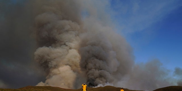 Members of the news media photograph the Route Fire Wednesday, Aug. 31, 2022, in Castaic, California.