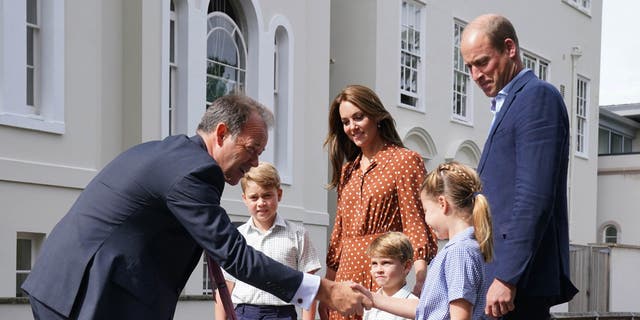 Prince George, Kate Middleton, Prince Louis, Prince William, and Princess Charlotte are greeted by Headmaster Jonathan Perry (L) upon their arrival at Lambrook School on Sept. 7, 2022, on the eve of their first school day. 