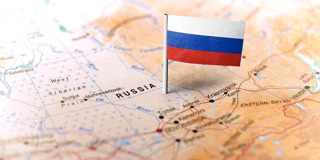 FILE- The flag of Russia pinned on the map. 