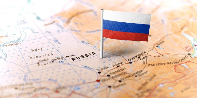 FILE- The flag of Russia pinned on the map.