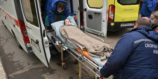 A child injured in a school shooting in central Russia gets loaded onto an ambulance in Izhevsk, Russia, on Sept. 27, 2022.