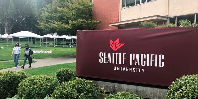 Students, faculty and staff at the Seattle Pacific University are suing its board of trustees for refusing to scrap an employment policy barring people in same-sex relationships from full-time jobs. Pictured: Students walking on the campus of Seattle Pacific University in Washington on Sept. 11, 2022.