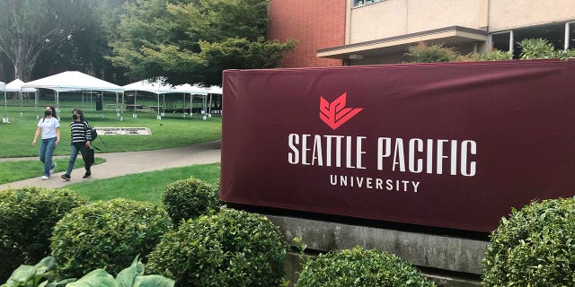 Students, faculty and staff at the Seattle Pacific University are suing its board of trustees for refusing to scrap an employment policy barring people in same-sex relationships from full-time jobs. Pictured: Students walking on the campus of Seattle Pacific University in Washington on Sept. 11, 2022.